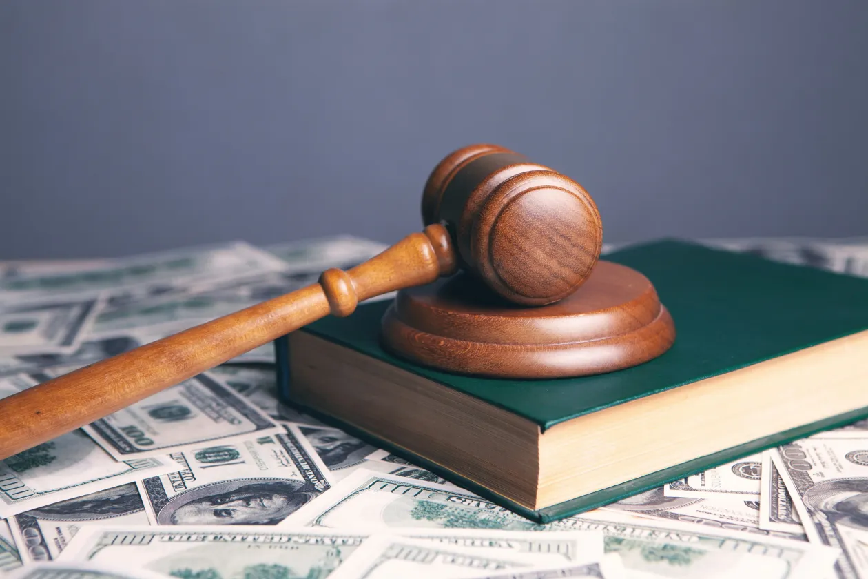 Gavel on top of book on top of money