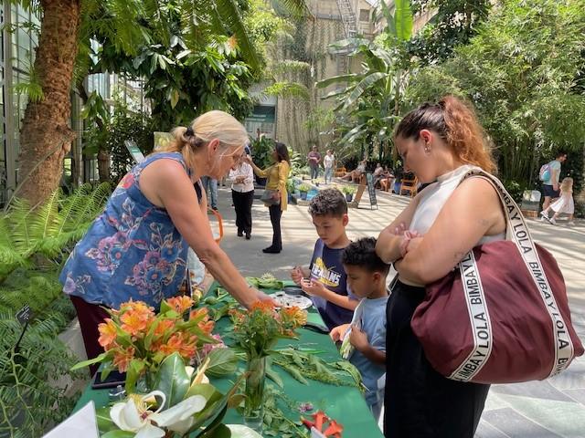 Devin Reese showing plants to visitors 