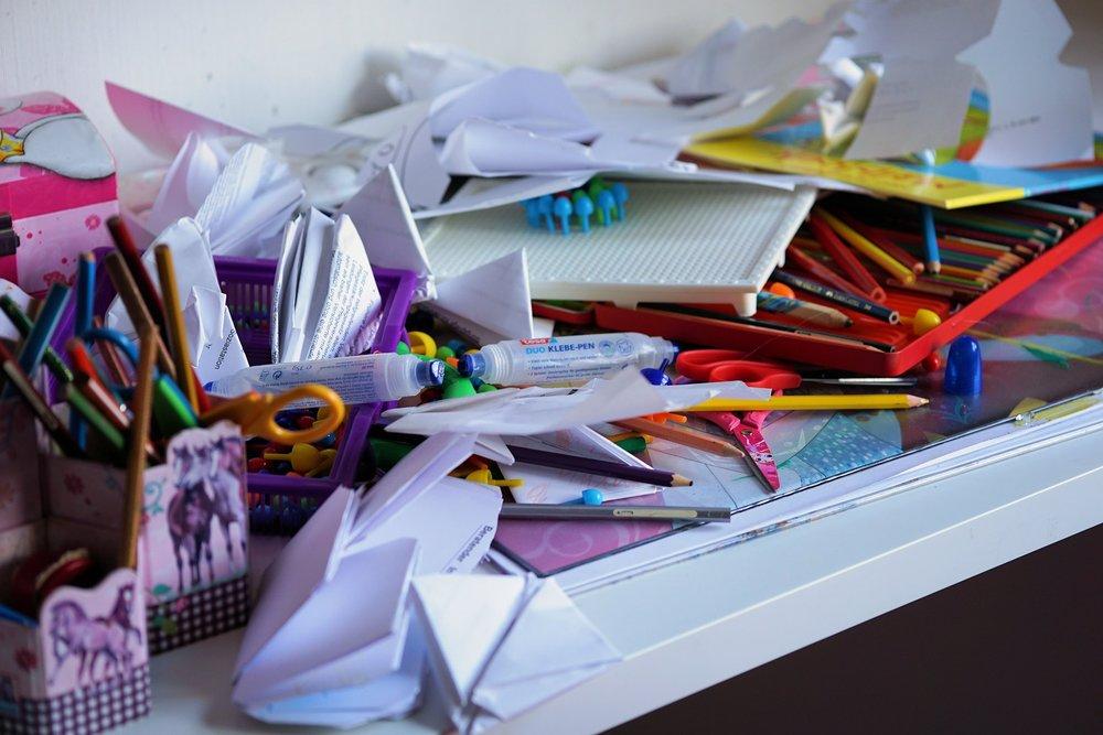Image of paper and pencils cluttered on a table