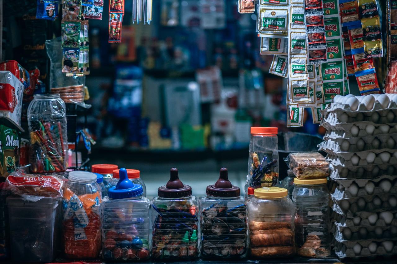Piles of snacks, candy, and eggs hanging from a street stand. Photo by Igor Ovsyannykov on Unsplash.