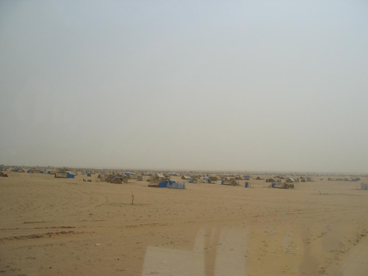 Dozens of tents in a desert. By Patrick Christian.