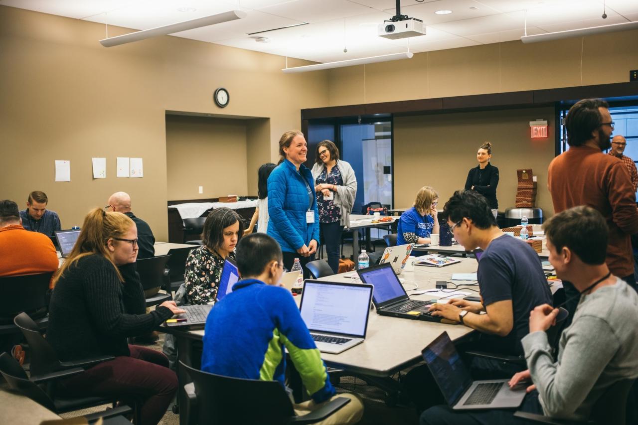 People sitting in front of laptops, by Alexa Earlywine.