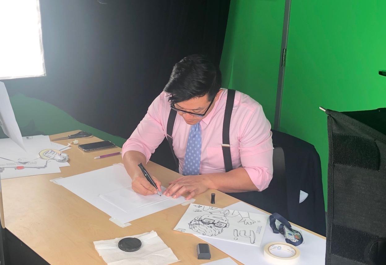STPF fellow Vince Tedjasaputra writing at a desk.