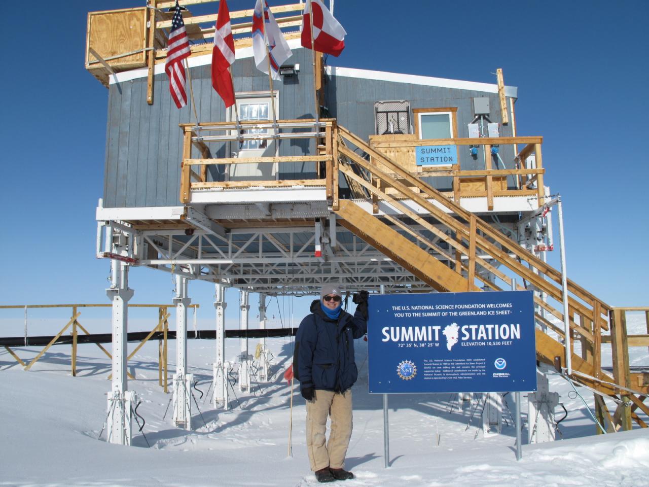 Robert Delgado stands in front of the Summit Station in Greenland