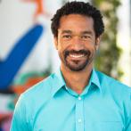 Smiling Black man in a blue shirt 