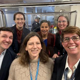Fellows in the STPF Rapid Response AI Cohort pose together for a photo in the Capital subway.