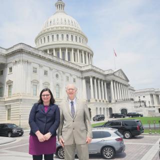 Adriana Bankston with Representative Foster, standing side by side outside the U.S. Capitol.
