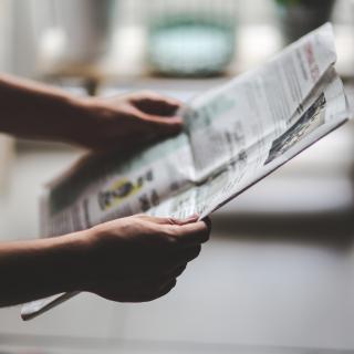 Person reading a newspaper