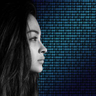 Side profile of a woman in front of a background of binary code.