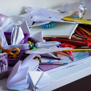 Image of paper and pencils cluttered on a table