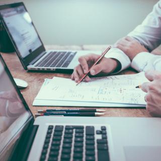 Hands working at laptops. Image by Unsplash.