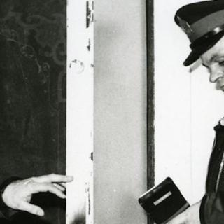 Black and white photo of a police officer.