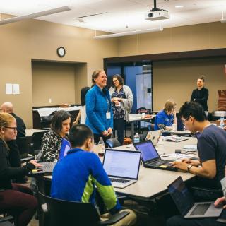 People sitting in front of laptops, by Alexa Earlywine.