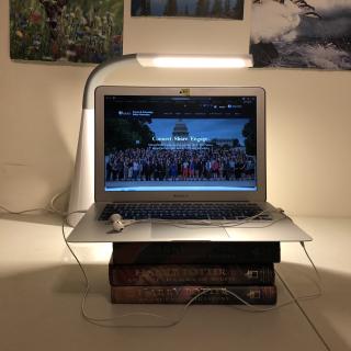 A video interview set up of a lap top on a stack of books.
