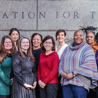 Group photo of STPF staff standing in front of the AAAS building. 